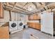 This functional laundry room features modern washer and dryer units, ample storage cabinets, and a convenient utility sink at 2121 W 73Rd Pl, Denver, CO 80221
