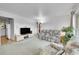 Bright living room features a cozy seating area and a tv for entertainment at 2121 W 73Rd Pl, Denver, CO 80221