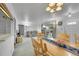 Open concept: view of dining area into living room with couch, chair, and large windows at 2121 W 73Rd Pl, Denver, CO 80221
