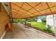 Covered patio area with a concrete floor, seating, and view of the backyard and shed at 2121 W 73Rd Pl, Denver, CO 80221