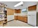 A versatile room features bright lighting, linoleum floors, storage shelves, cabinets, and a vintage-style refrigerator at 2121 W 73Rd Pl, Denver, CO 80221