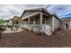 Backyard with covered porch, fire pit, and gravel landscaping at 22662 E Narrowleaf Cir, Aurora, CO 80016