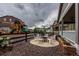 Backyard features fire pit seating, play area, and gravel landscaping at 22662 E Narrowleaf Cir, Aurora, CO 80016