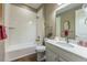 Bright bathroom featuring tub, updated vanity, and wood-look flooring at 22662 E Narrowleaf Cir, Aurora, CO 80016