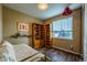 Charming bedroom featuring built-in bookshelves and wood-look flooring at 22662 E Narrowleaf Cir, Aurora, CO 80016