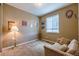 Cozy bedroom with seating area, neutral walls, and a large window for natural light at 22662 E Narrowleaf Cir, Aurora, CO 80016
