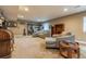 Comfortable living room features neutral tones, plush seating, and bright recessed lighting at 22662 E Narrowleaf Cir, Aurora, CO 80016
