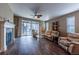Open floor plan with a fireplace and hardwood floors that connect kitchen and living spaces at 22662 E Narrowleaf Cir, Aurora, CO 80016