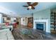 Open floor plan with a fireplace and hardwood floors that connect kitchen and living spaces at 22662 E Narrowleaf Cir, Aurora, CO 80016
