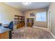 Office space features built-in shelving, neutral walls, and carpeted flooring at 22662 E Narrowleaf Cir, Aurora, CO 80016