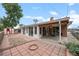 Backyard featuring a brick patio, sunroom, shed, garden, and privacy fence at 8205 Pennsylvania St, Denver, CO 80229