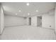 Spacious unfinished basement with concrete flooring, recessed lighting, and framed openings for future rooms at 8205 Pennsylvania St, Denver, CO 80229
