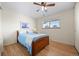 Bedroom features hardwood floors, natural light and a wooden bed frame at 8205 Pennsylvania St, Denver, CO 80229