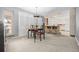 Dining area with a view into the kitchen featuring tile floors and large windows for natural light at 8205 Pennsylvania St, Denver, CO 80229