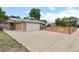 Charming brick home features a two-car garage and a spacious concrete driveway at 8205 Pennsylvania St, Denver, CO 80229