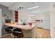 Eat-in kitchen with white cabinetry and tile floors, great for cooking and entertaining guests at 8205 Pennsylvania St, Denver, CO 80229