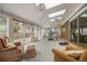 Bright sunroom with skylights, brick accents, large windows and sliding glass doors, perfect for relaxation and entertainment at 8205 Pennsylvania St, Denver, CO 80229