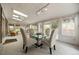 Bright sunroom featuring skylights, track lighting and glass table with seating for four at 8205 Pennsylvania St, Denver, CO 80229