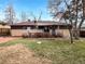 Spacious backyard with patio area, mature trees, and privacy landscaping at 13477 E Center Ave, Aurora, CO 80012
