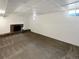 Spacious basement area featuring a brick fireplace and neutral carpeting for versatile use at 13477 E Center Ave, Aurora, CO 80012