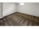 Partially finished basement area showcasing built-in shelving and neutral carpeting at 13477 E Center Ave, Aurora, CO 80012