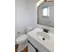 Modern bathroom with white vanity, bronze fixtures, and new toilet at 13477 E Center Ave, Aurora, CO 80012