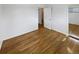 Bedroom with hardwood floors, closet, and open doorway at 13477 E Center Ave, Aurora, CO 80012
