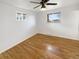 Bright bedroom with hardwood floors, two windows, and a ceiling fan at 13477 E Center Ave, Aurora, CO 80012