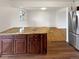 Modern kitchen with stainless steel appliances, granite countertops, and wooden cabinets at 13477 E Center Ave, Aurora, CO 80012