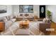 Bright living room with neutral decor, large window, and stylish furnishings at 13477 E Center Ave, Aurora, CO 80012