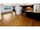 Open concept living room with hardwood floors leading to kitchen with stainless steel appliances at 13477 E Center Ave, Aurora, CO 80012