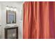 Bathroom features stylish glass bowl sink, storage cabinet, vanity mirror and bright lights at 701 Harlan St # E29, Lakewood, CO 80214