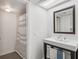 Bathroom features a large mirror, stylish sink, vanity and shower with striped curtain at 701 Harlan St # E29, Lakewood, CO 80214