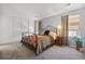 Cozy bedroom features carpeted floors, closet, a window and comfortable bed at 701 Harlan St # E29, Lakewood, CO 80214