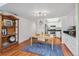 Open dining area featuring wood floors, blue rug, shelving unit and bright kitchen with stainless appliances at 701 Harlan St # E29, Lakewood, CO 80214