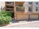 Multi-story condo exterior with individual garages, private balconies, and landscaped surroundings at 701 Harlan St # E29, Lakewood, CO 80214