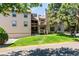 Attractive multi-level condo building with green lawn and mature trees at 701 Harlan St # E29, Lakewood, CO 80214