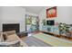 Inviting living room features a fireplace, balcony access, and bright decor at 701 Harlan St # E29, Lakewood, CO 80214