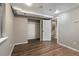 Finished basement features wood flooring, closet, and access to stairs at 7476 E Arkansas Ave # 1-03, Denver, CO 80231