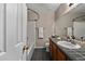 Cozy bathroom featuring tile countertops and floors, and a shower-tub combo at 7476 E Arkansas Ave # 1-03, Denver, CO 80231