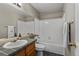 Bathroom with a tiled countertop and floors, and shower-tub combo at 7476 E Arkansas Ave # 1-03, Denver, CO 80231