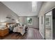 Sunlit bedroom with wood floors, a skylight and a sliding door closet at 7476 E Arkansas Ave # 1-03, Denver, CO 80231
