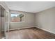 Light-filled bedroom with hardwood floors and a closet with sliding doors at 7476 E Arkansas Ave # 1-03, Denver, CO 80231