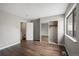 Bedroom with new hardwood floors and closet featuring sliding mirror doors at 7476 E Arkansas Ave # 1-03, Denver, CO 80231