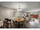 Dining area with modern chandelier open to living area at 7476 E Arkansas Ave # 1-03, Denver, CO 80231