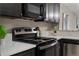 Close up of updated kitchen with stainless steel stove and white countertop at 7476 E Arkansas Ave # 1-03, Denver, CO 80231