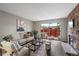 Bright living room with a decorative stone fireplace and a sliding glass door to a private patio at 7476 E Arkansas Ave # 1-03, Denver, CO 80231