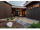 Backyard with covered patio, stone path, and landscaping at 11229 Running Kit Pl, Franktown, CO 80116