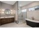 Elegant bathroom featuring a walk-in shower, modern vanity, and stylish lighting at 11229 Running Kit Pl, Franktown, CO 80116