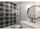 Chic bathroom with bold tile shower, modern vanity, and stylish mirror at 11229 Running Kit Pl, Franktown, CO 80116